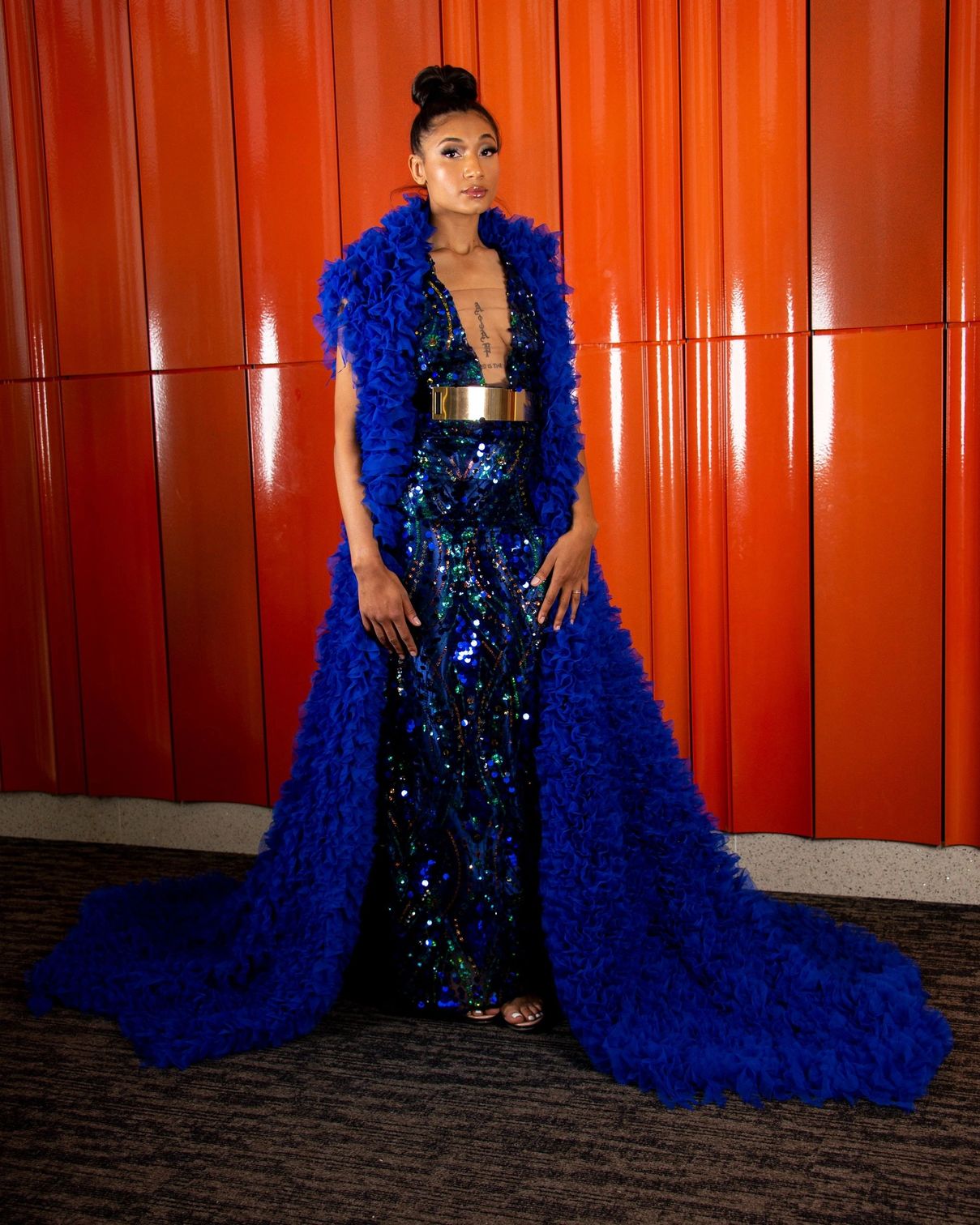 Blue sequin gown with a dramatic royal-blue ruffled coat and train
