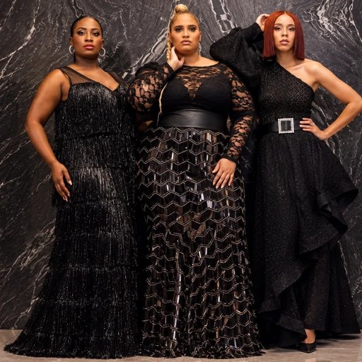 Three models in black gowns against black marble — a tiered fringe gown, a lace-bodice gown with a zigzag sequin skirt, and a one-shoulder gown with a ruffled wrap
